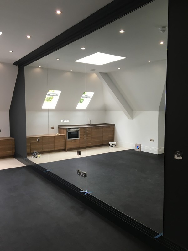 Frameless glass partition in loft conversion by South Kensington glaziers