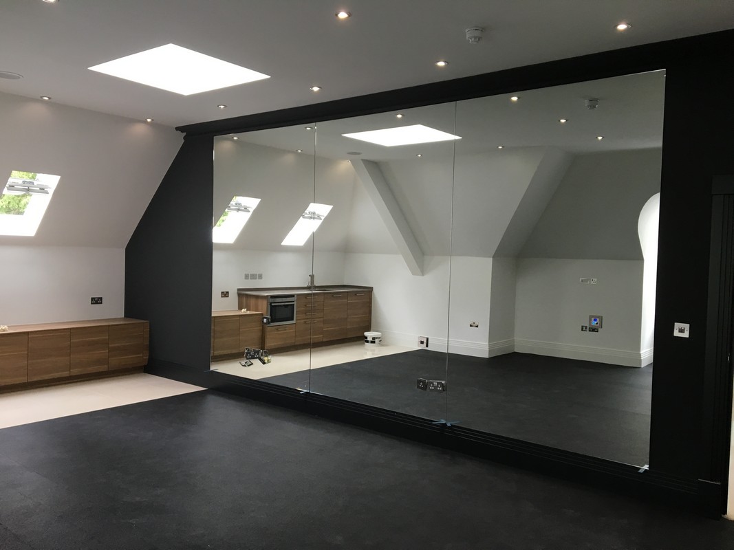 Frameless glass wall dividing loft conversion in South Kensington