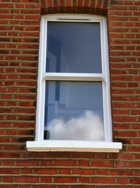 uPVC sash window on Victorian red brick house in South Kensington